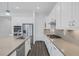 Bright kitchen boasts white cabinets, stainless steel appliances, a spacious island, and modern finishes at 11617 Peregrine Point Ct, Las Vegas, NV 89138