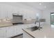 Detailed view of the kitchen island, sink, faucet, and stainless steel appliances at 11617 Peregrine Point Ct, Las Vegas, NV 89138
