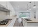 Modern kitchen featuring stainless steel appliances, white cabinetry, and large center island at 11617 Peregrine Point Ct, Las Vegas, NV 89138