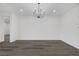 Bright living room with modern chandelier, light gray flooring and lots of natural light at 11617 Peregrine Point Ct, Las Vegas, NV 89138