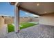 Covered patio overlooking an artificial grass yard and a paved sitting area for outdoor enjoyment at 11617 Peregrine Point Ct, Las Vegas, NV 89138