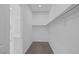 Walk-in closet with neutral carpet, white walls and shelving with a window at 11617 Peregrine Point Ct, Las Vegas, NV 89138