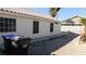 Beige house featuring a tile roof, several black-framed windows, and a mostly dirt backyard at 1214 Emerald Stone Ave, North Las Vegas, NV 89081