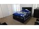 This bedroom features carpet and a large bed at 1214 Emerald Stone Ave, North Las Vegas, NV 89081