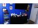 Bright bedroom with blue walls, storage, and a TV at 1214 Emerald Stone Ave, North Las Vegas, NV 89081