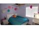 A bedroom featuring a neatly made bed, floral decorations and natural light from the window at 1214 Emerald Stone Ave, North Las Vegas, NV 89081