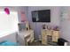 This bedroom features a well-lit vanity and television at 1214 Emerald Stone Ave, North Las Vegas, NV 89081