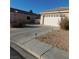 Home exterior showing the garage, landscaping, and driveway on a sunny day at 1214 Emerald Stone Ave, North Las Vegas, NV 89081