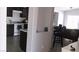 Open-concept kitchen and living area with dark cabinets and eat-in bar at 1214 Emerald Stone Ave, North Las Vegas, NV 89081