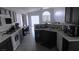 Bright kitchen with white countertops, dark cabinets, and an open view to the living area at 1214 Emerald Stone Ave, North Las Vegas, NV 89081
