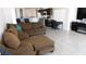 Spacious living room with a large sectional sofa and open view to the kitchen at 1214 Emerald Stone Ave, North Las Vegas, NV 89081