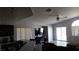 Spacious living area with dark cabinets, a large TV, and a cozy sofa at 1214 Emerald Stone Ave, North Las Vegas, NV 89081