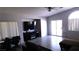 Living area featuring a tv, vaulted ceilings and view of the sliding glass door at 1214 Emerald Stone Ave, North Las Vegas, NV 89081