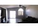 Bright living room with vaulted ceilings, tile flooring, and a sliding glass door at 1214 Emerald Stone Ave, North Las Vegas, NV 89081