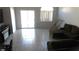 Bright living room with sliding glass doors, and a neutral-toned sofa at 1214 Emerald Stone Ave, North Las Vegas, NV 89081