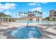 Relax in the community hot tub and pool area, with nearby seating, palm trees, and clubhouse at 1525 Spiced Wine Ave # 14105, Henderson, NV 89074
