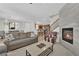 Open-concept living room with modern fireplace and comfortable seating at 1525 Spiced Wine Ave # 14105, Henderson, NV 89074