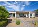 Outdoor patio features a stone walkway, neutral color scheme, covered patio, and solar panels at 1613 Williamsport St, Henderson, NV 89052