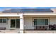 Covered patio with solar panels, tile flooring, and outdoor dining furniture at 1613 Williamsport St, Henderson, NV 89052