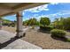 View of the backyard with desert landscaping, rock ground cover, and covered patio area with scenic views at 1613 Williamsport St, Henderson, NV 89052