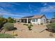 Exterior of home featuring backyard with desert landscaping and solar panels at 1613 Williamsport St, Henderson, NV 89052