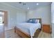 Bright bedroom features wood floors, shuttered windows, a ceiling fan, and a spacious closet at 1613 Williamsport St, Henderson, NV 89052