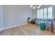 Bright bedroom features light wood floors, white trim, and a window with plantation shutters at 1613 Williamsport St, Henderson, NV 89052