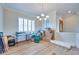 Neutral dining room with crown molding, window shutters, and light wood-look flooring at 1613 Williamsport St, Henderson, NV 89052