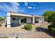 Back exterior view of house featuring covered patio and low maintenance landscaping at 1613 Williamsport St, Henderson, NV 89052