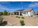 Back of house features desert landscaping, solar panels, and covered patio area at 1613 Williamsport St, Henderson, NV 89052