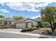 Single-story home featuring a three-car garage, desert landscaping and a tile roof at 1613 Williamsport St, Henderson, NV 89052
