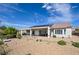 Back exterior showing desert landscaping, covered patio, and solar panels at 1613 Williamsport St, Henderson, NV 89052