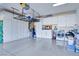 Spacious garage features overhead storage, built-in cabinets, a washer, and a dryer at 1613 Williamsport St, Henderson, NV 89052