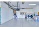 Spacious garage features overhead storage, built-in cabinets, a washer, and a dryer at 1613 Williamsport St, Henderson, NV 89052