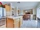 Bright kitchen featuring a kitchen island, stainless steel refrigerator, light wood cabinets, and breakfast nook at 1613 Williamsport St, Henderson, NV 89052