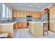 Bright kitchen with stainless steel appliances, center island, stone backsplash, and white tile flooring at 1613 Williamsport St, Henderson, NV 89052