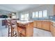 Kitchen featuring a center island with seating, stone backsplash, and white countertops at 1613 Williamsport St, Henderson, NV 89052