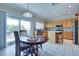 Eat-in kitchen features stainless steel appliances, light wood cabinets, and sliding door to patio at 1613 Williamsport St, Henderson, NV 89052