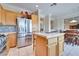 Kitchen featuring stainless steel appliances, stone backsplash, and white tile flooring at 1613 Williamsport St, Henderson, NV 89052