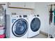 Bright laundry room with white washer and dryer and storage cabinets at 1613 Williamsport St, Henderson, NV 89052