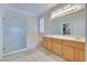 Elegant bathroom features a glass shower, soaking tub, double vanity, and generous counter space at 1613 Williamsport St, Henderson, NV 89052