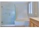 Serene bathroom with a glass-enclosed shower, soaking tub, and natural light from a window at 1613 Williamsport St, Henderson, NV 89052