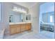Bright bathroom showcasing a double vanity, a walk-in shower, and generous counter space at 1613 Williamsport St, Henderson, NV 89052