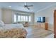 Bright main bedroom offering a bay window, hardwood flooring, and a television at 1613 Williamsport St, Henderson, NV 89052