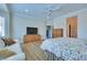 Bright bedroom with hardwood flooring, ceiling fan, television, and an ensuite bathroom at 1613 Williamsport St, Henderson, NV 89052
