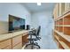 Home office features custom built-in cabinetry, a built-in desk, and tile flooring at 1613 Williamsport St, Henderson, NV 89052