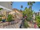 Landscaped backyard featuring tropical plants, and exterior shade structure at 1672 Cloister Ave, Henderson, NV 89014