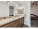 Bathroom with double sinks, granite countertop, and ceiling lighting at 1672 Cloister Ave, Henderson, NV 89014