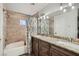 Bathroom with granite countertops, dual sinks and tub with shower at 1672 Cloister Ave, Henderson, NV 89014