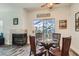 Breakfast nook featuring a gas fireplace, glass table and chairs, and access to the patio at 1672 Cloister Ave, Henderson, NV 89014
